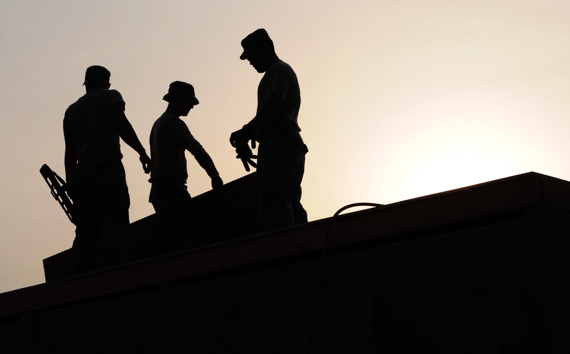 workers on top of roof