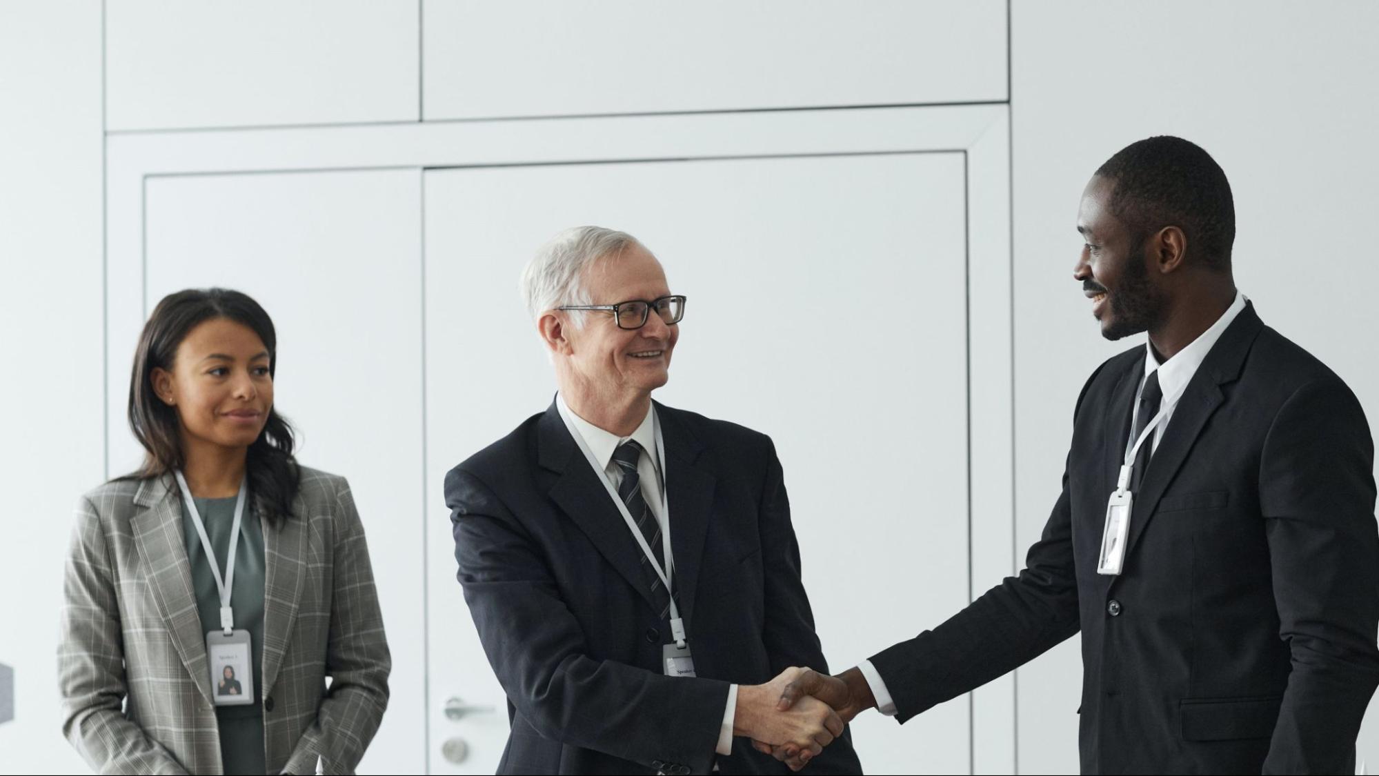business persons meeting together and shaking hands