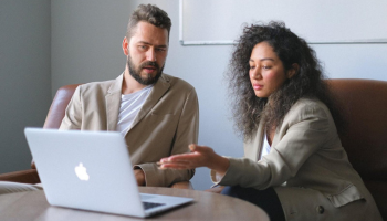 Man and woman looking at the laptop.